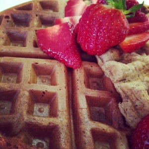 Paleo-friendly waffles garnished with strawberries. So good that you don't even need syrup!!! 
